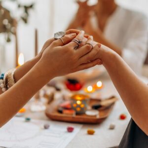 A serene indoor Reiki healing session with focus on hands, crystals, and a calming atmosphere.