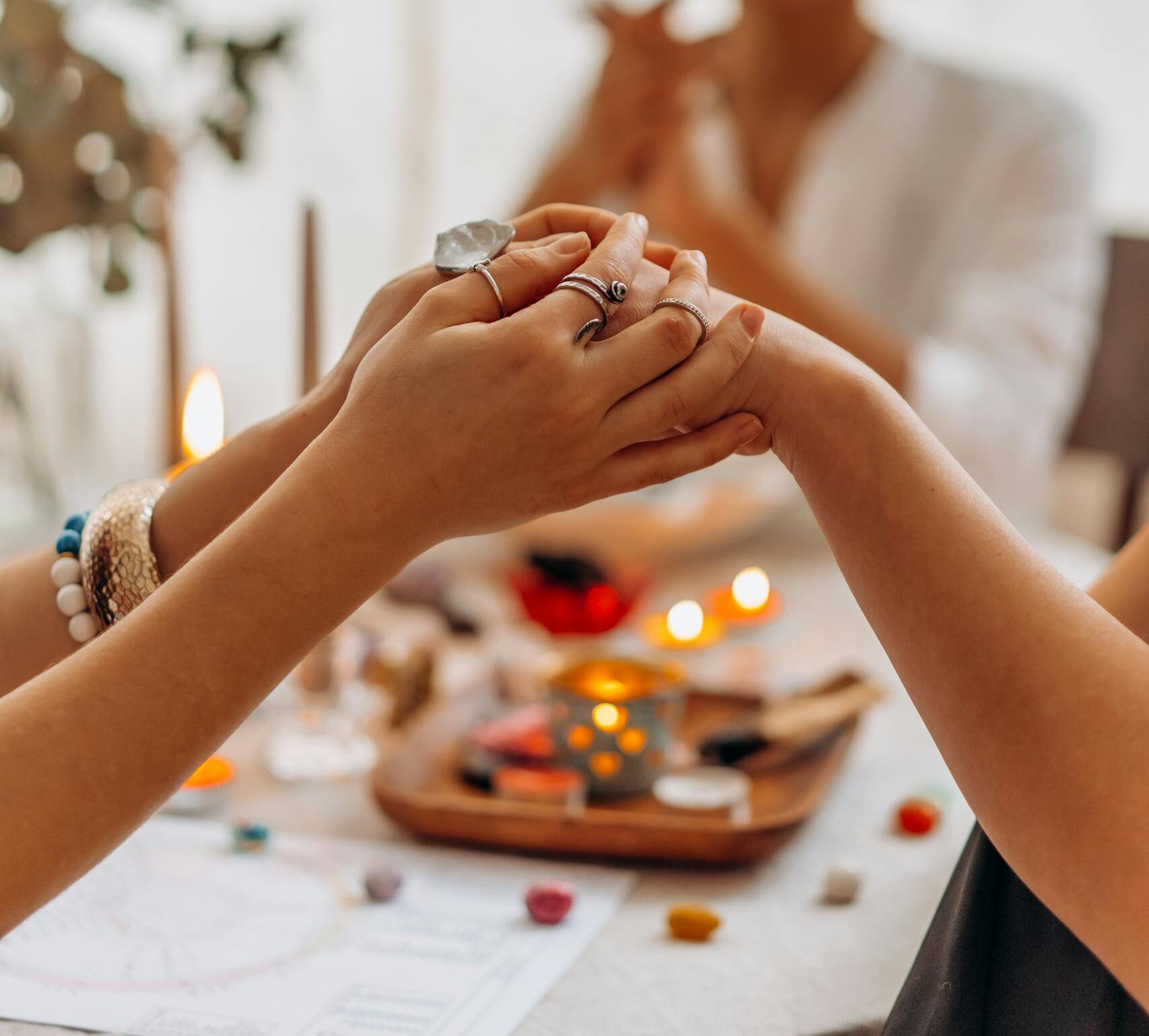 A serene indoor Reiki healing session with focus on hands, crystals, and a calming atmosphere.